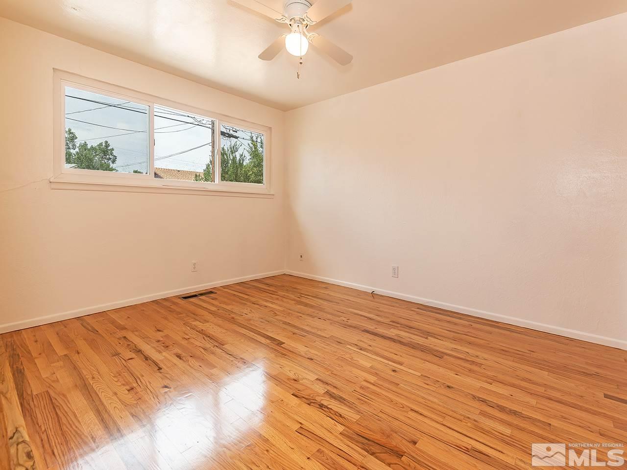1775 West 6th Street Reno, NV 89503 - Photo 8 of 15 a view of empty room with wooden floor and fan