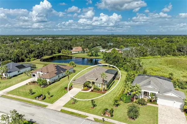 an aerial view of a house with a swimming pool outdoor seating and yard