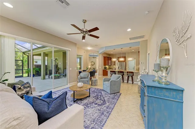 a room with stainless steel appliances granite countertop a sink a stove and a refrigerator