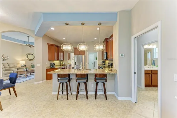 a spacious bedroom with a bed and a chandelier