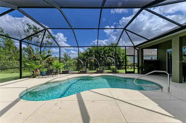 an aerial view of a house with a garden and swimming pool