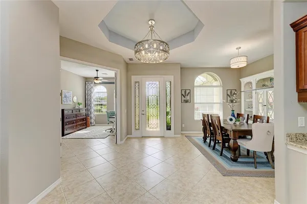 a view of a hallway view with wooden floor and a living room