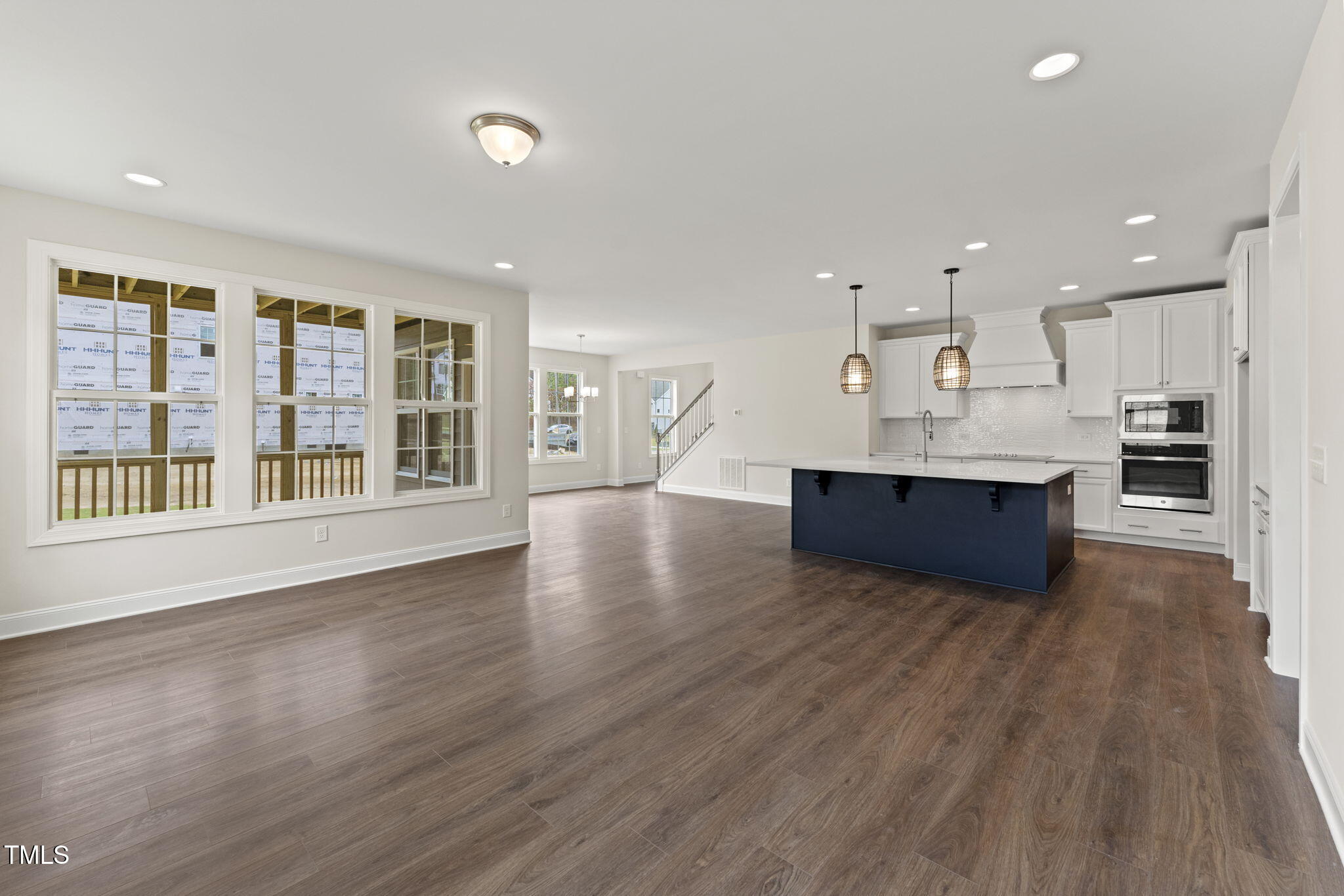 134 Ivy Rdg Road Chapel Hill, NC 27516 - Photo 12 of 37 a living room with stainless steel appliances kitchen island wooden floors and large window