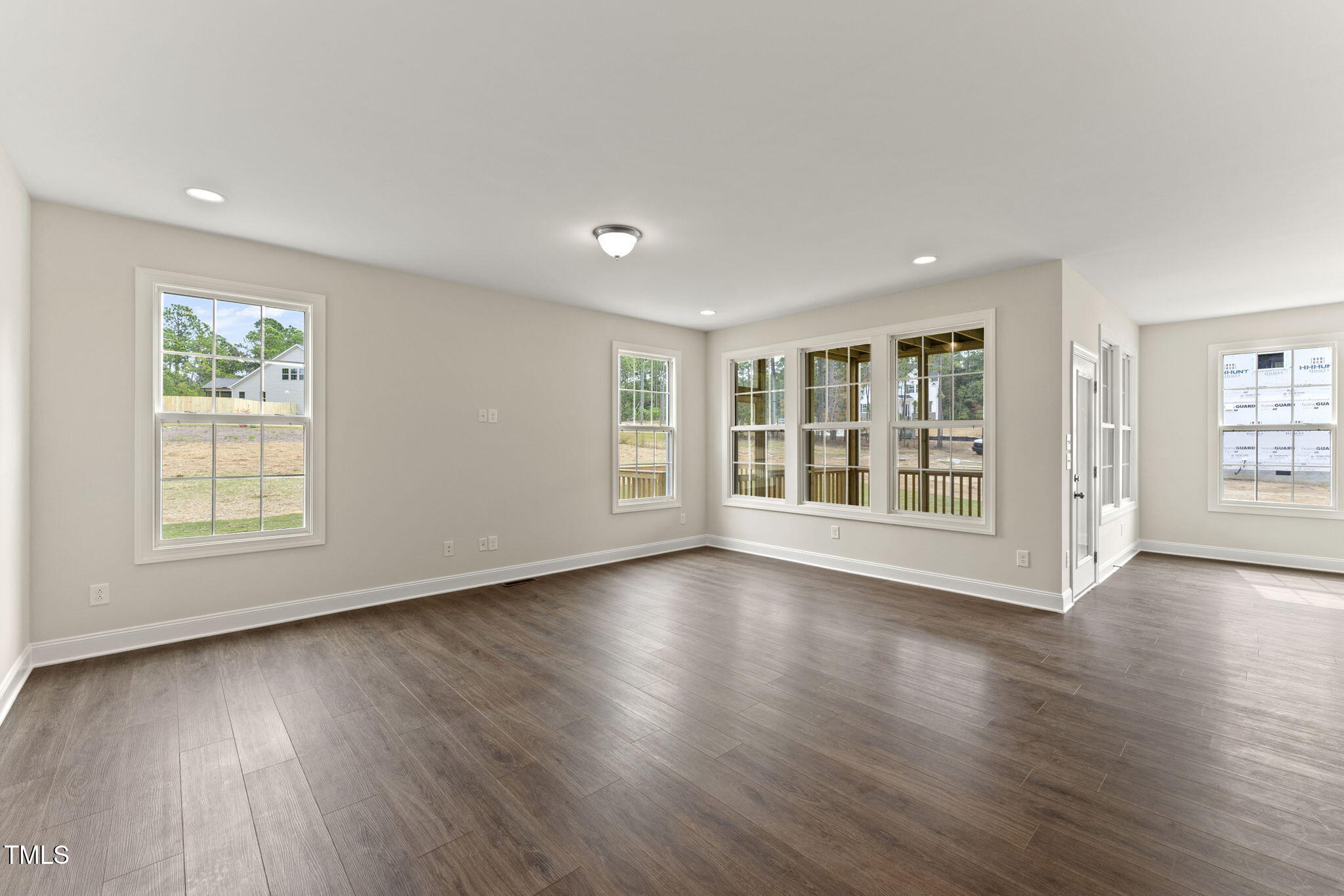 134 Ivy Rdg Road Chapel Hill, NC 27516 - Photo 13 of 37 a view of an empty room with wooden floor and a window