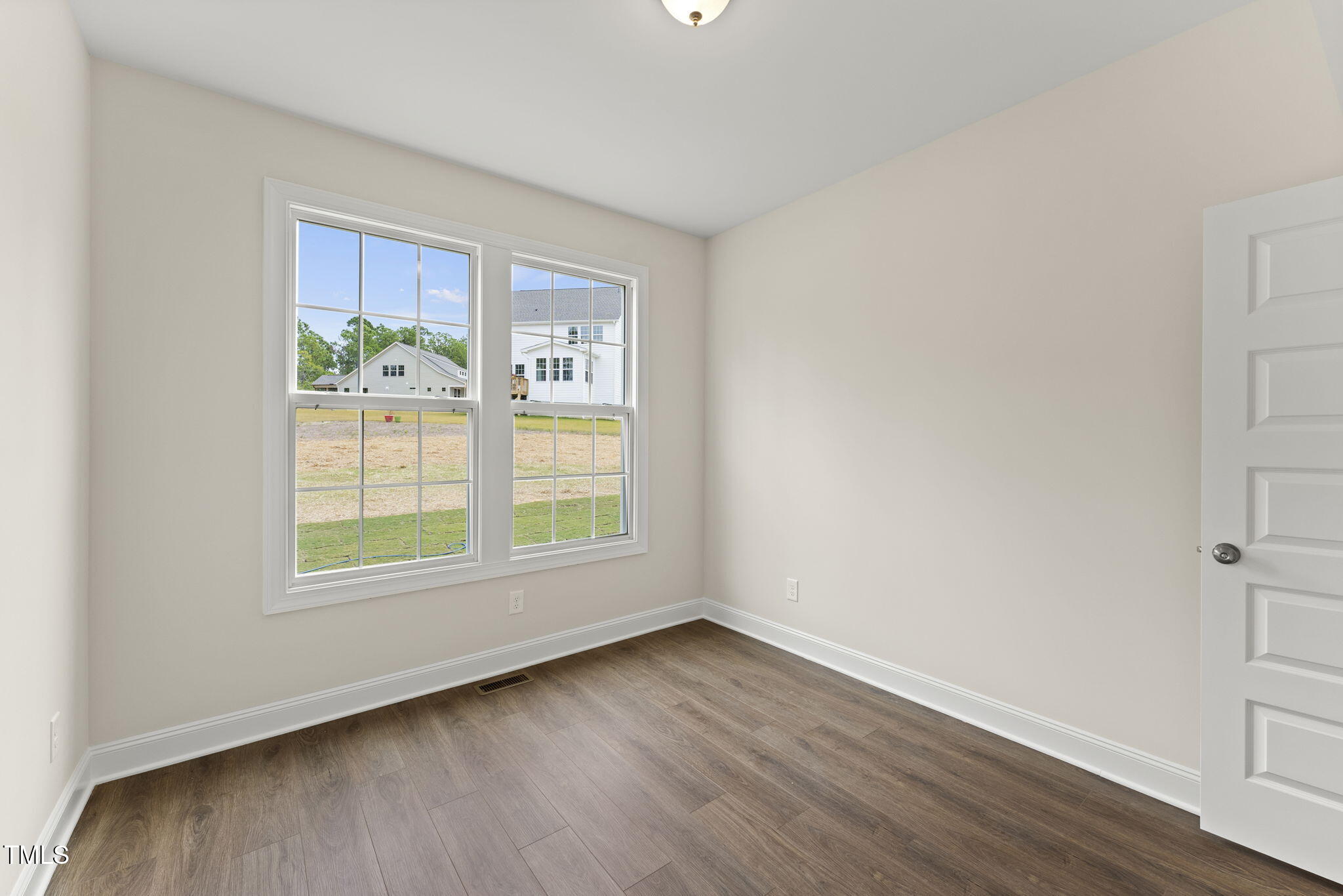 134 Ivy Rdg Road Chapel Hill, NC 27516 - Photo 16 of 37 an empty room with wooden floor and windows