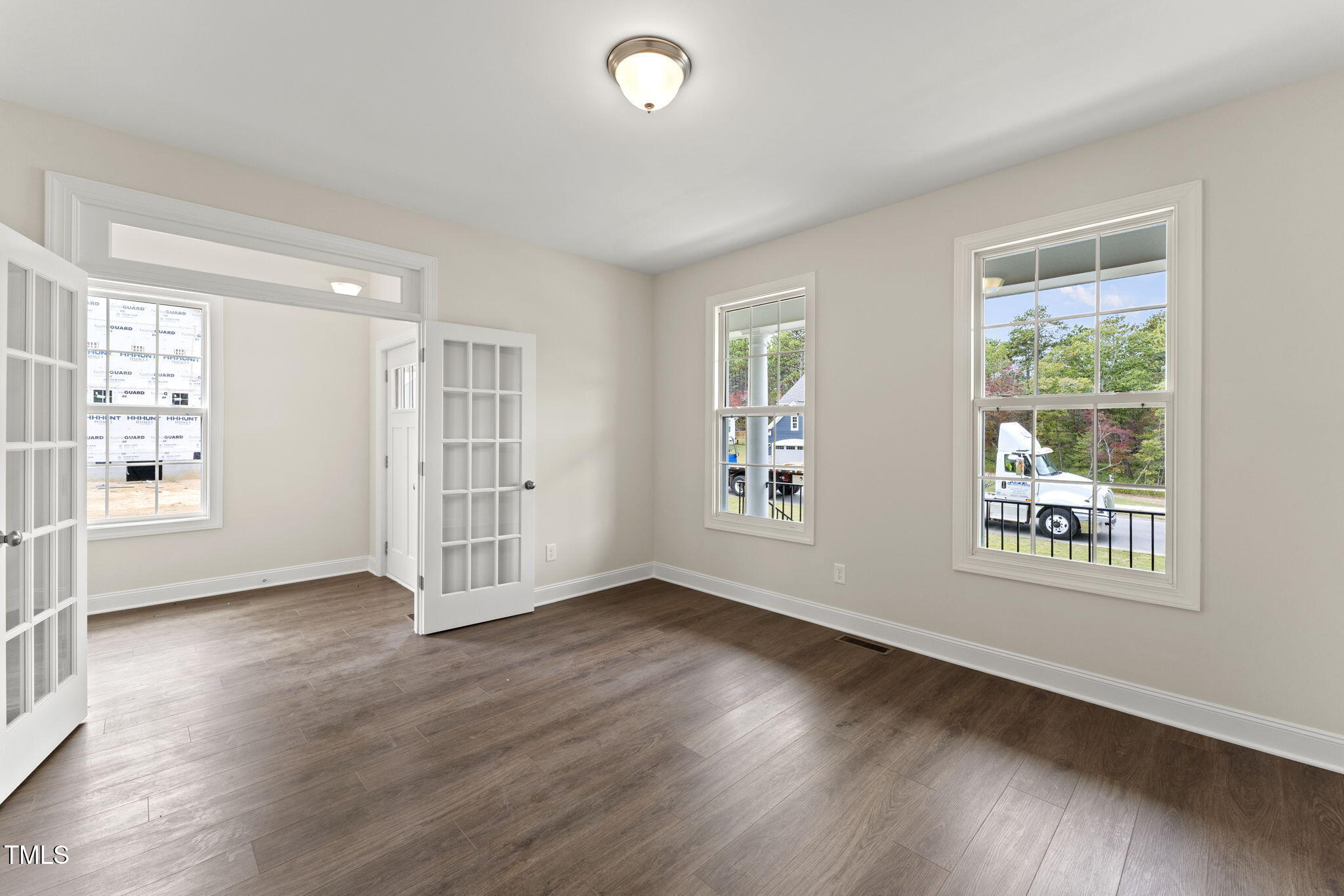 134 Ivy Rdg Road Chapel Hill, NC 27516 - Photo 4 of 37 a view of an empty room with a window and wooden floor