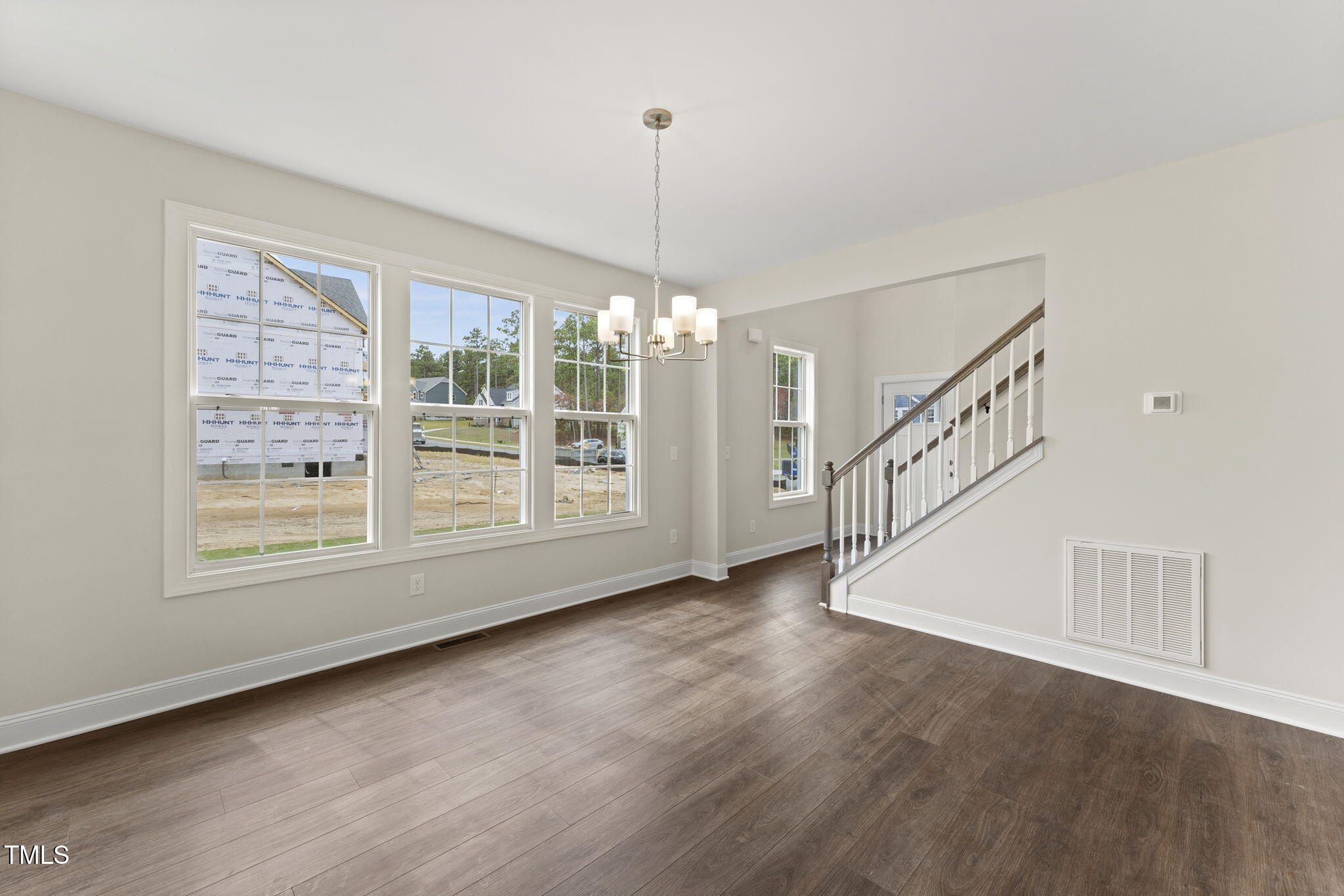 134 Ivy Rdg Road Chapel Hill, NC 27516 - Photo 5 of 37 a view of an empty room with wooden floor and a window