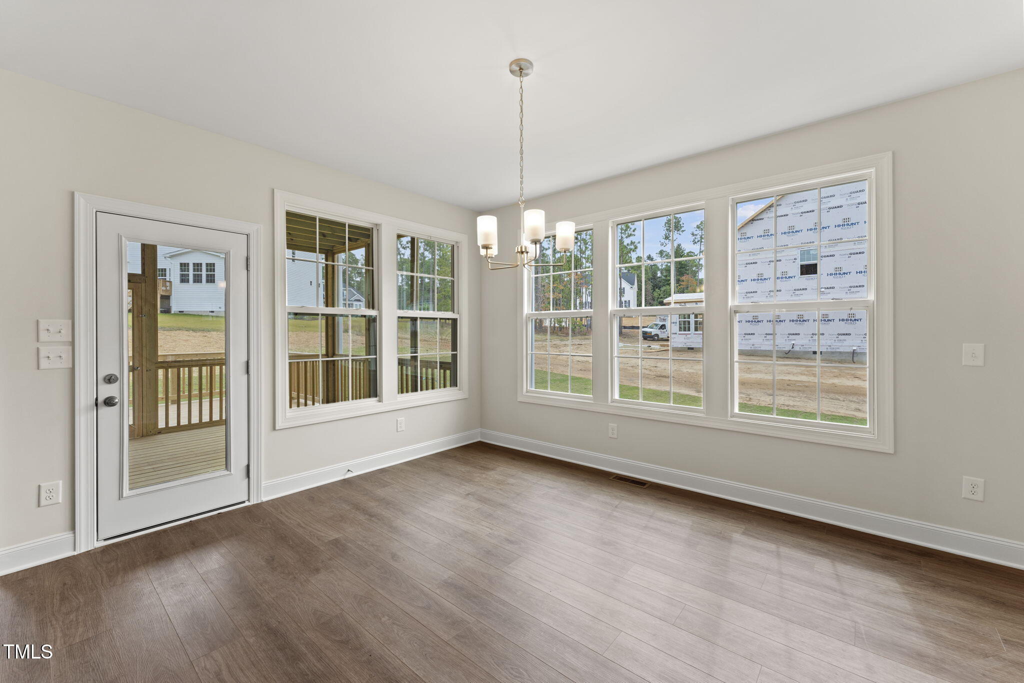 134 Ivy Rdg Road Chapel Hill, NC 27516 - Photo 6 of 37 a view of an empty room with a window and wooden floor