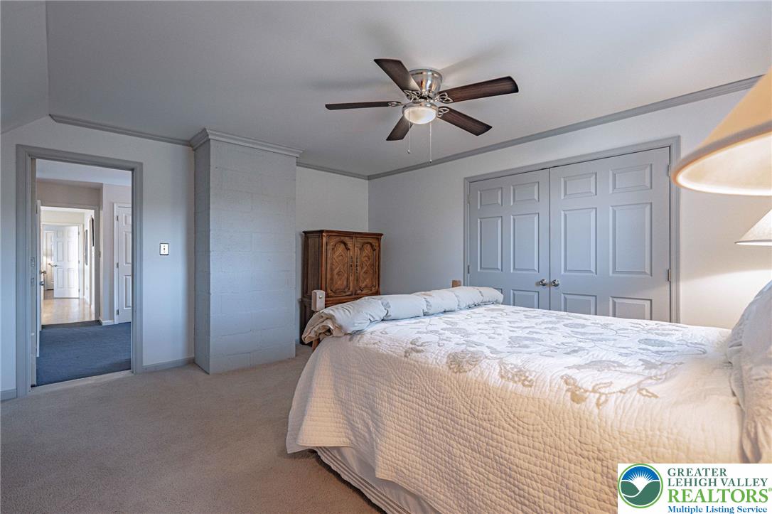 4542 Springfield Drive Coplay, PA 18037 - Photo 51 of 89 Comfortable bedroom retreat features soft carpeting, practical closet storage, and a cooling ceiling fan.