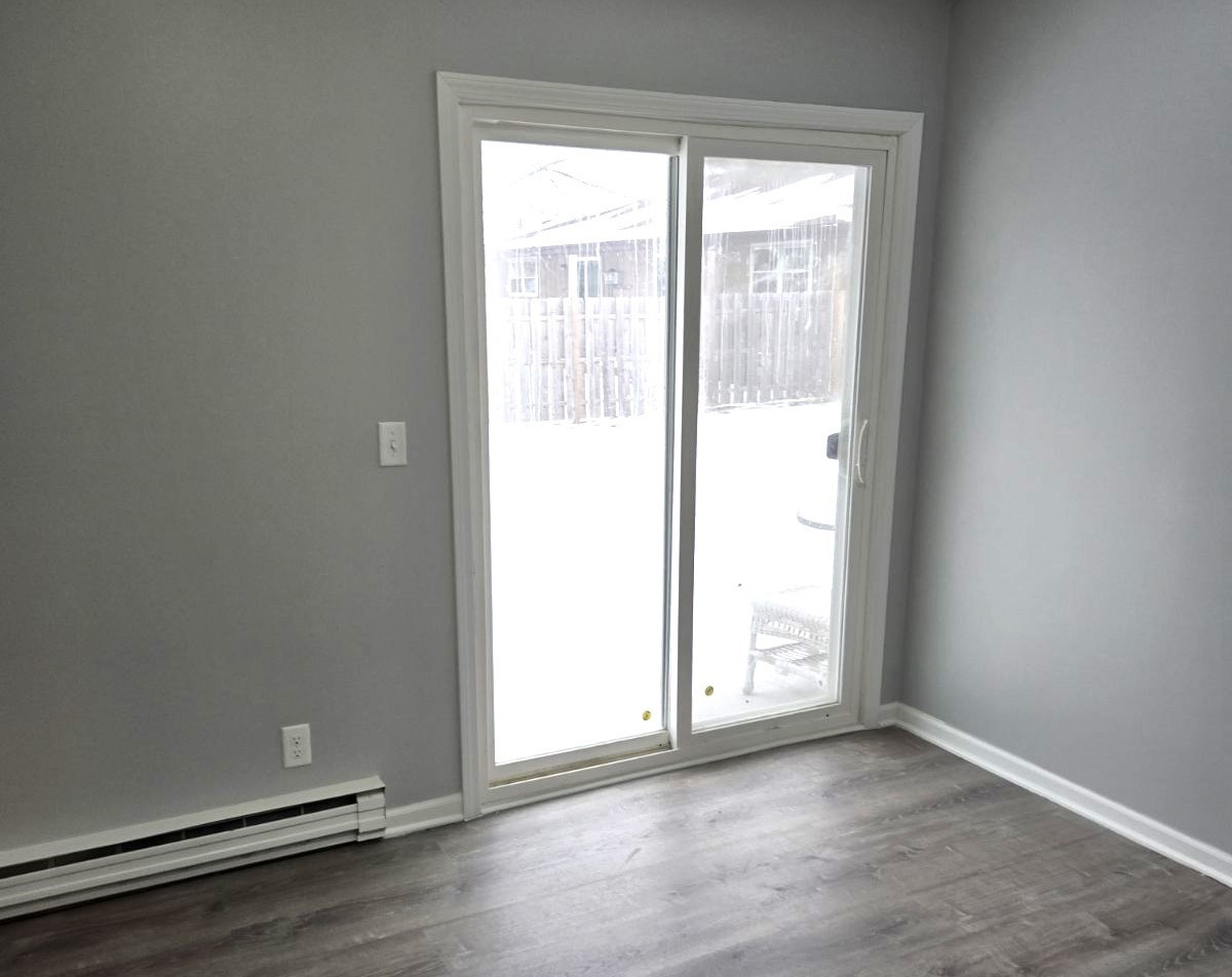 1014 Bratton Avenue, Unit 3 Marseilles, IL 61341 - Photo 7 of 11 an empty room with wooden floor and windows