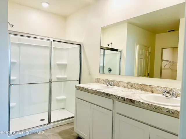 a bathroom with a granite countertop sink mirror and