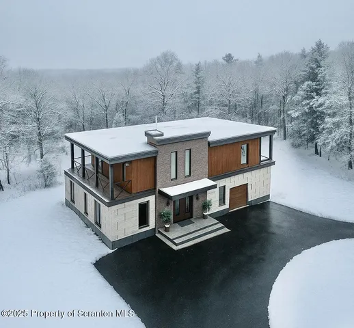 a view of a house with roof deck and sitting area