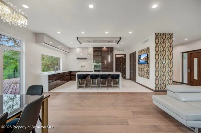 a living room with furniture a table and chairs