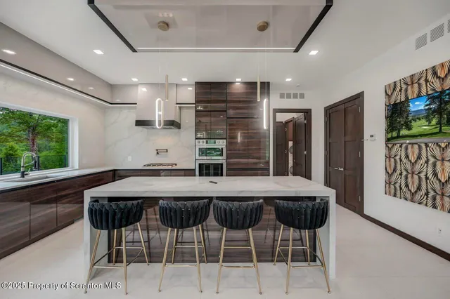 a view of a hallway with wooden floor and windows