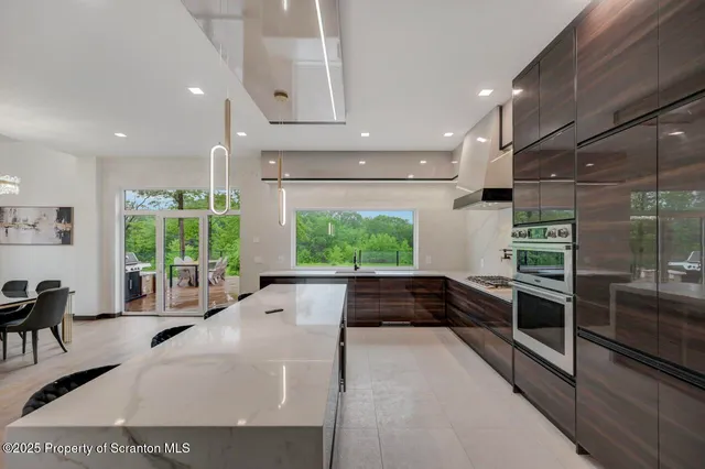 a reading room with wooden floor pool table and windows