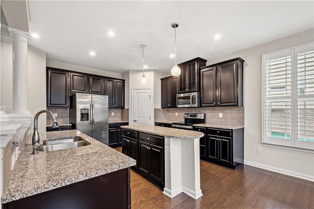 4441 Walnut Ridge Circle McDonald, PA 15057 - Photo 5 of 25 Kitchen boasts HW floors, SS appliances, granite countertops, espresso cabinetry, island, pantry & access to back deck.