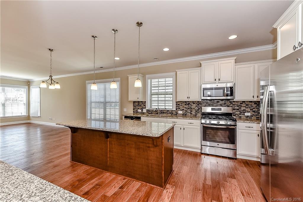 604 Brookhaven Drive, Unit HKC 95 Fort Mill, SC 29708 - Photo 12 of 24 a large kitchen with cabinets wooden floor and stainless steel appliances