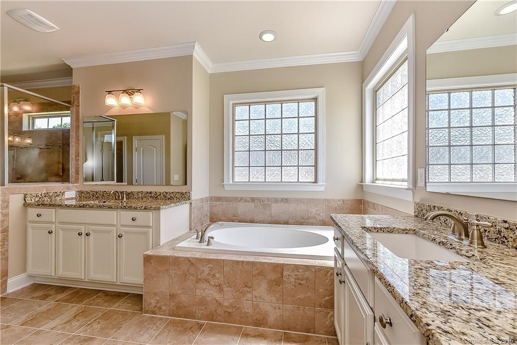 604 Brookhaven Drive, Unit HKC 95 Fort Mill, SC 29708 - Photo 14 of 24 a spacious bathroom with a granite countertop tub sink and mirror