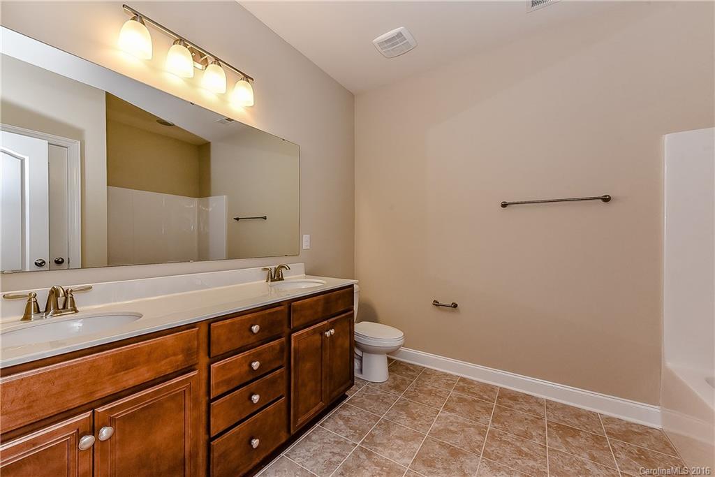 604 Brookhaven Drive, Unit HKC 95 Fort Mill, SC 29708 - Photo 22 of 24 a bathroom with a double vanity sink and mirror with toilet