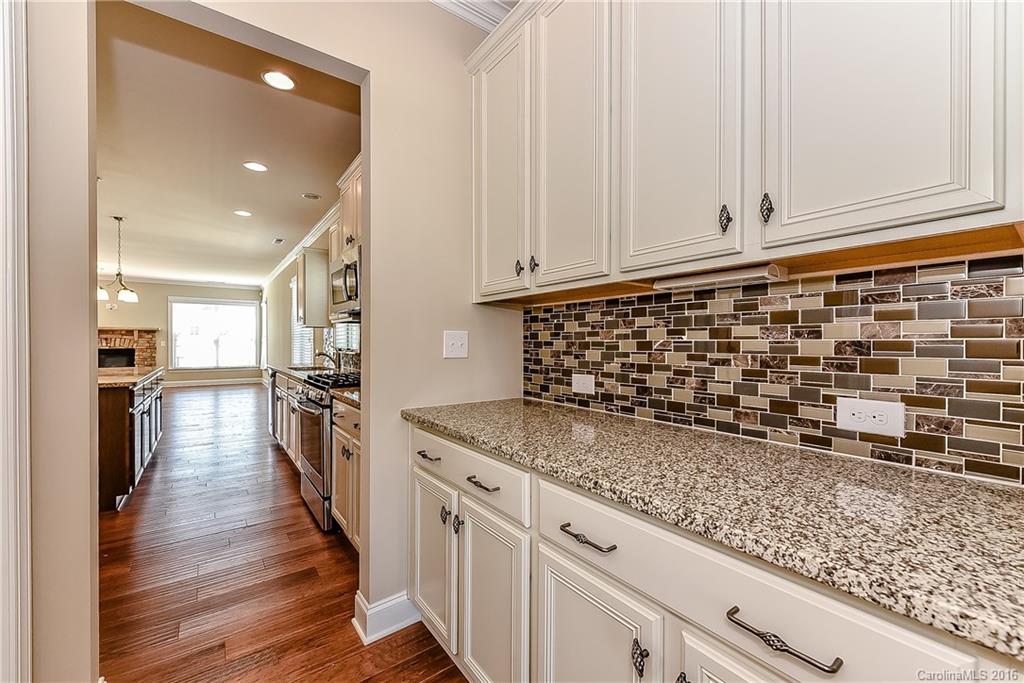 604 Brookhaven Drive, Unit HKC 95 Fort Mill, SC 29708 - Photo 7 of 24 a kitchen with granite countertop a stove a sink and a refrigerator