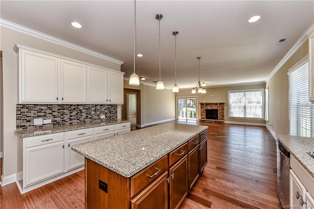 604 Brookhaven Drive, Unit HKC 95 Fort Mill, SC 29708 - Photo 9 of 24 a kitchen with stainless steel appliances granite countertop a sink a stove and a wooden floors