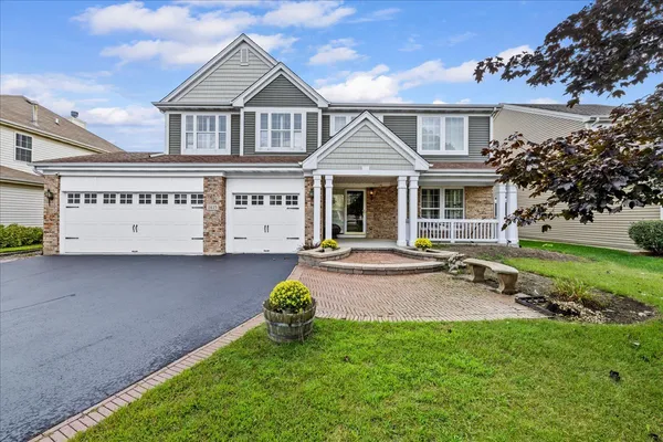 a front view of a house with a yard