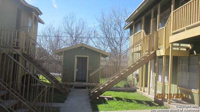a view of building with yard and deck