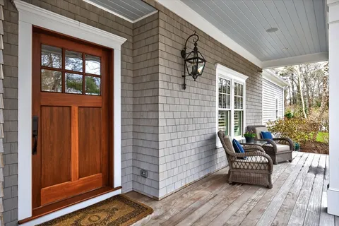 a view of balcony with furniture and wooden floor