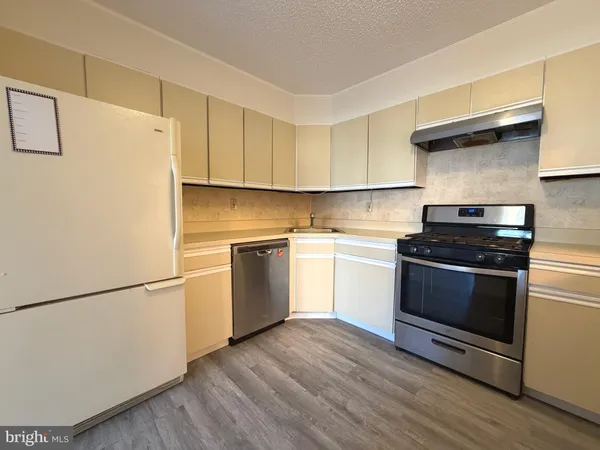 a kitchen with a white cabinets and white appliances