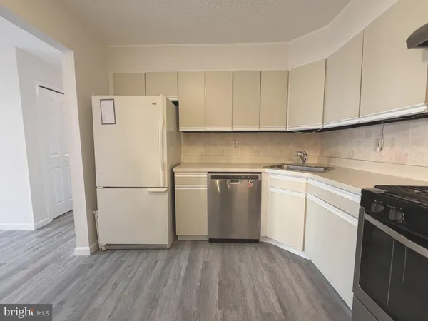 a white refrigerator freezer sitting inside of a kitchen
