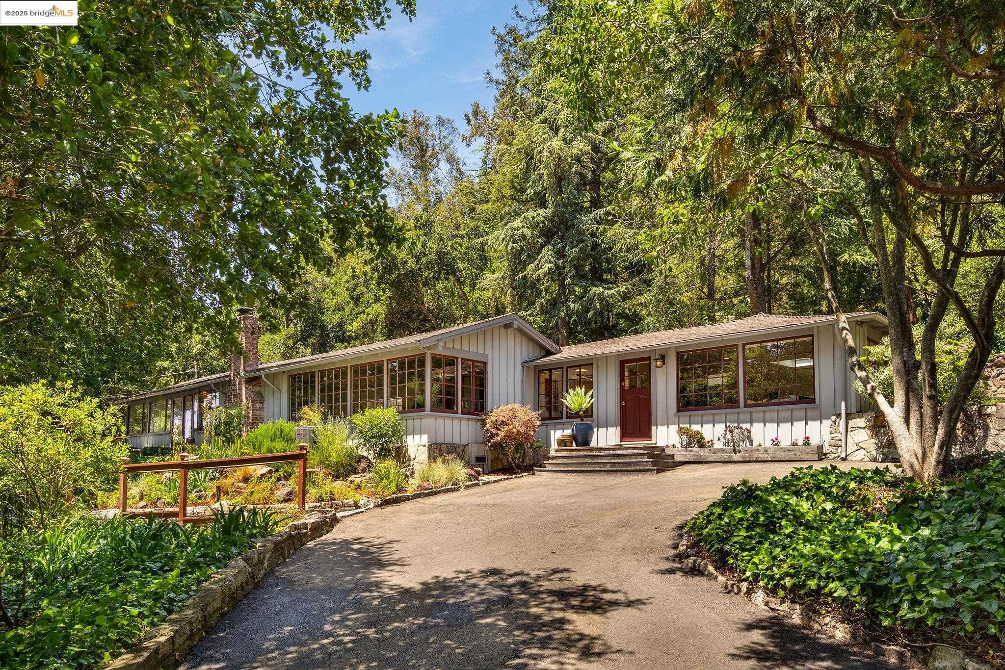 2976 Joaquin Miller Road Oakland, CA 94602 - Photo 1 of 1 a front view of a house with yard patio and green space