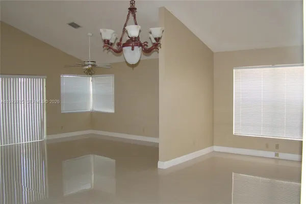 a view of a room with a windows and chandelier
