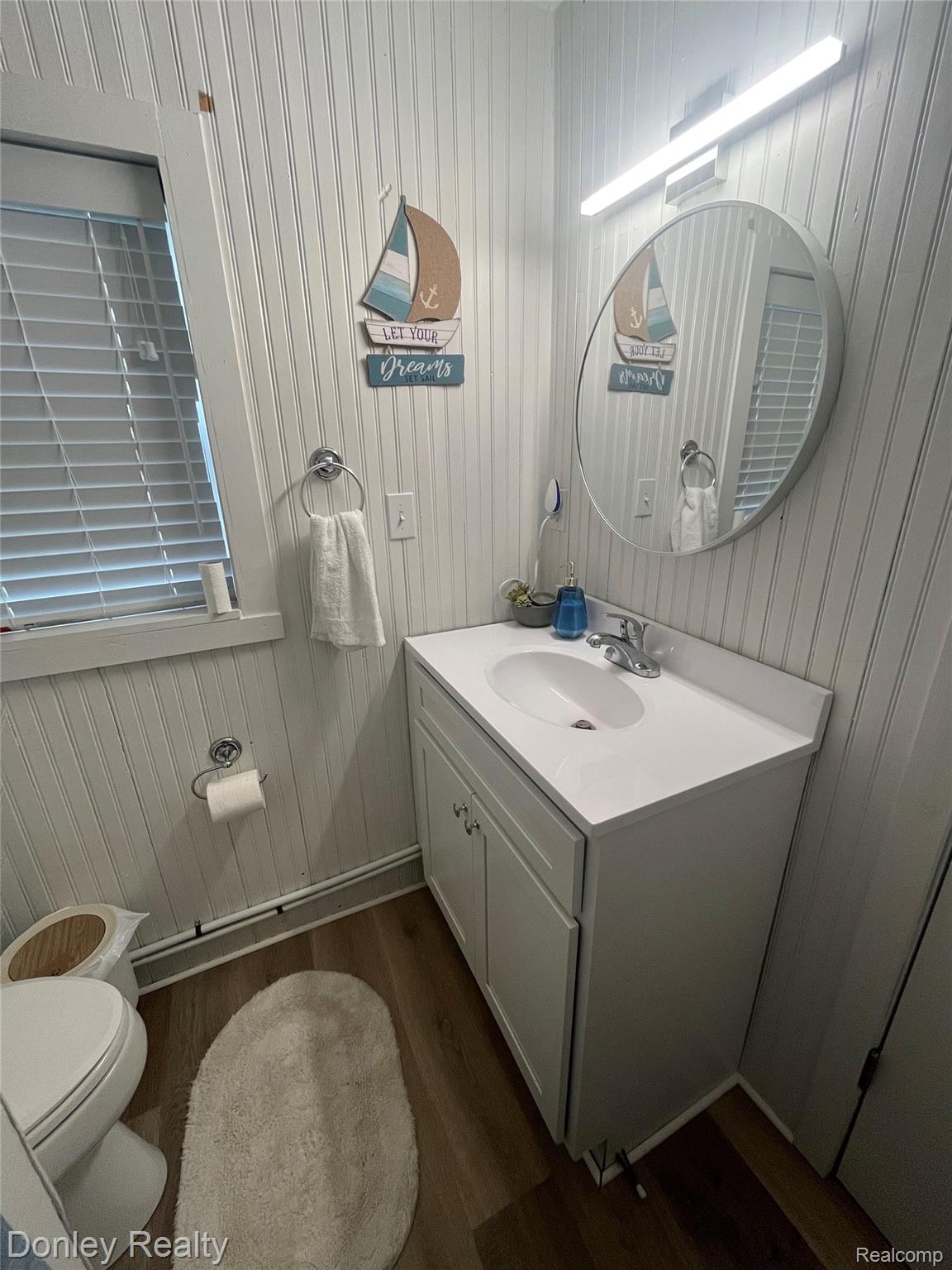 977 Port Austin Road Port Austin, MI 48467 - Photo 13 of 29 Bathroom featuring dark wood-type flooring and vanity