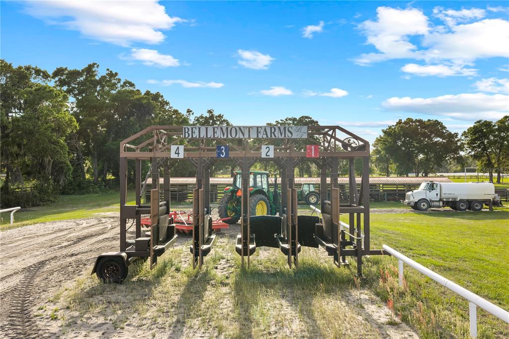 1345 Northeast 155th Place Citra, FL 32113 - Photo 2 of 42 a view of a swimming pool with lawn chairs and a fire pit