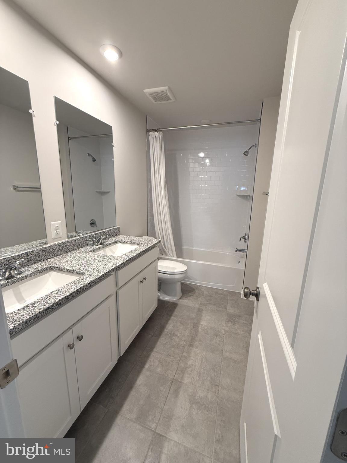 167 Coolidge Avenue Ranson, WV 25438 - Photo 14 of 20 a bathroom with a granite countertop sink and a mirror