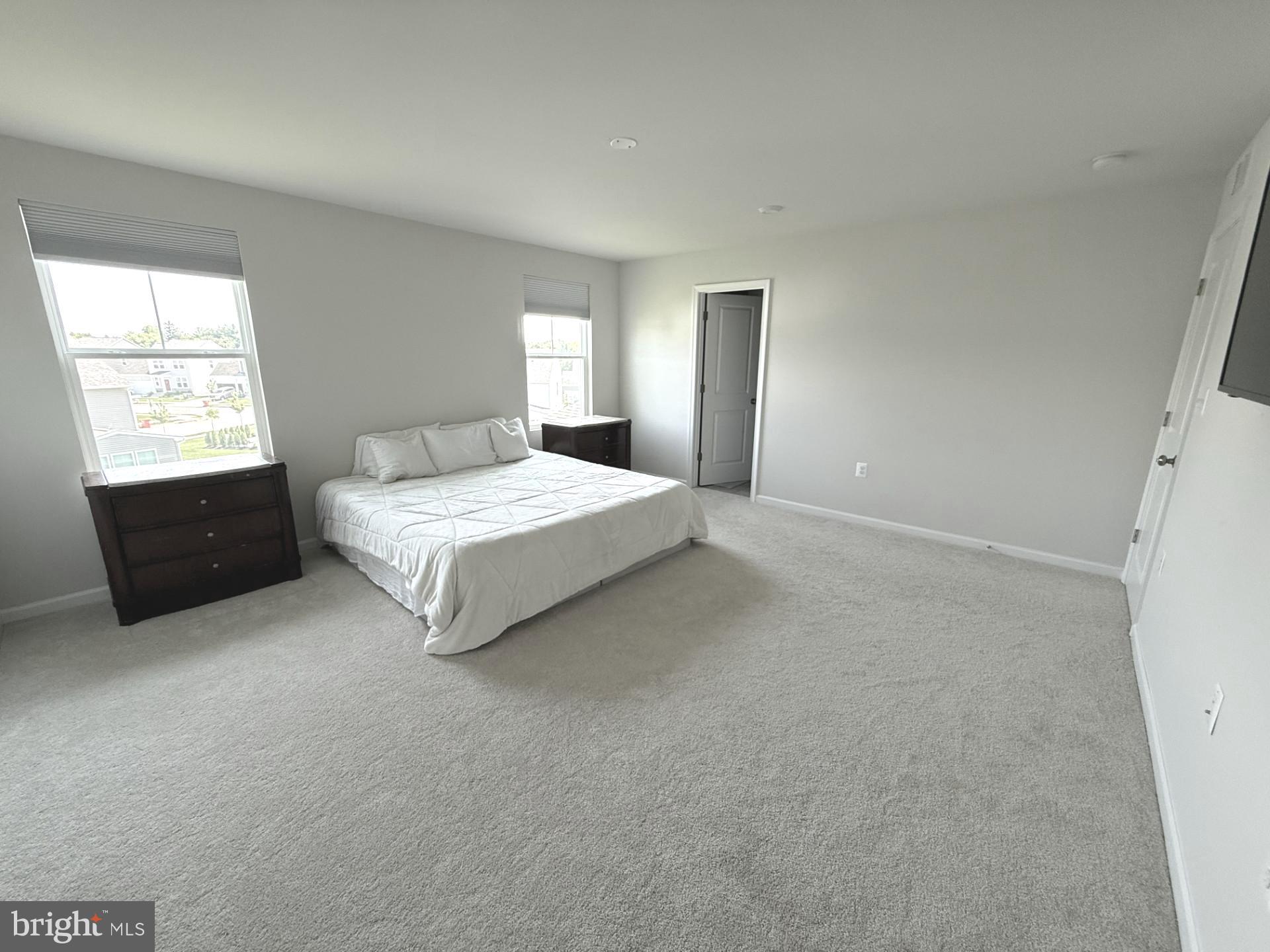 167 Coolidge Avenue Ranson, WV 25438 - Photo 8 of 20 a spacious bedroom with a bed and window
