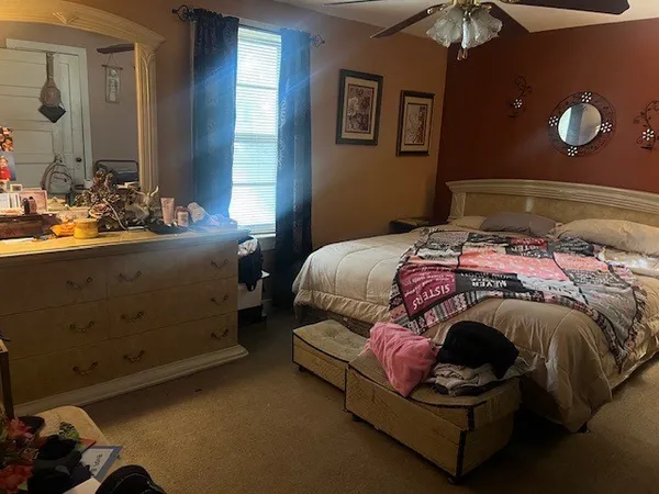a bedroom with a bed and a window