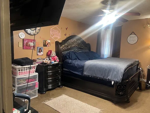 a bedroom with furniture and a chandelier