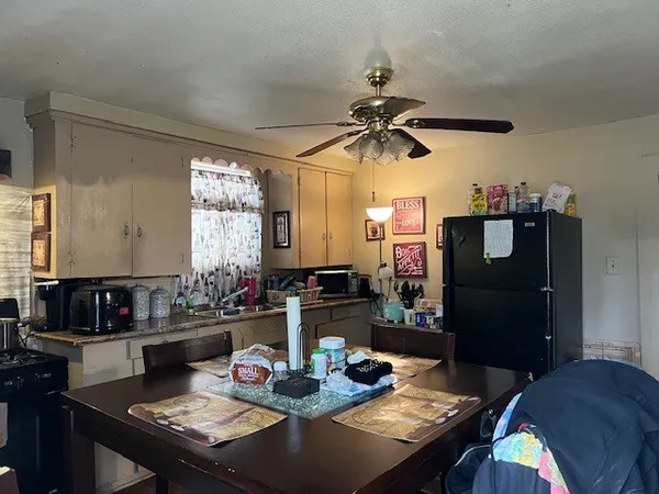 a view of a dining room with furniture and chandelier