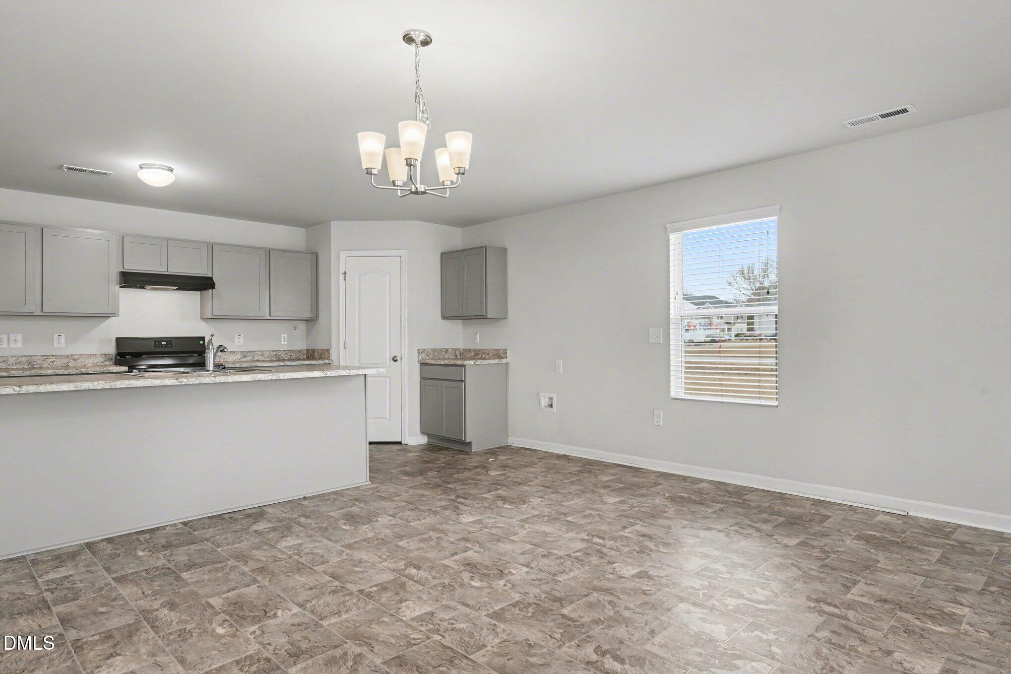 6003 Lowgrass Road Stedman, NC 28391 - Photo 11 of 24 a view of a kitchen with a sink cabinets and window