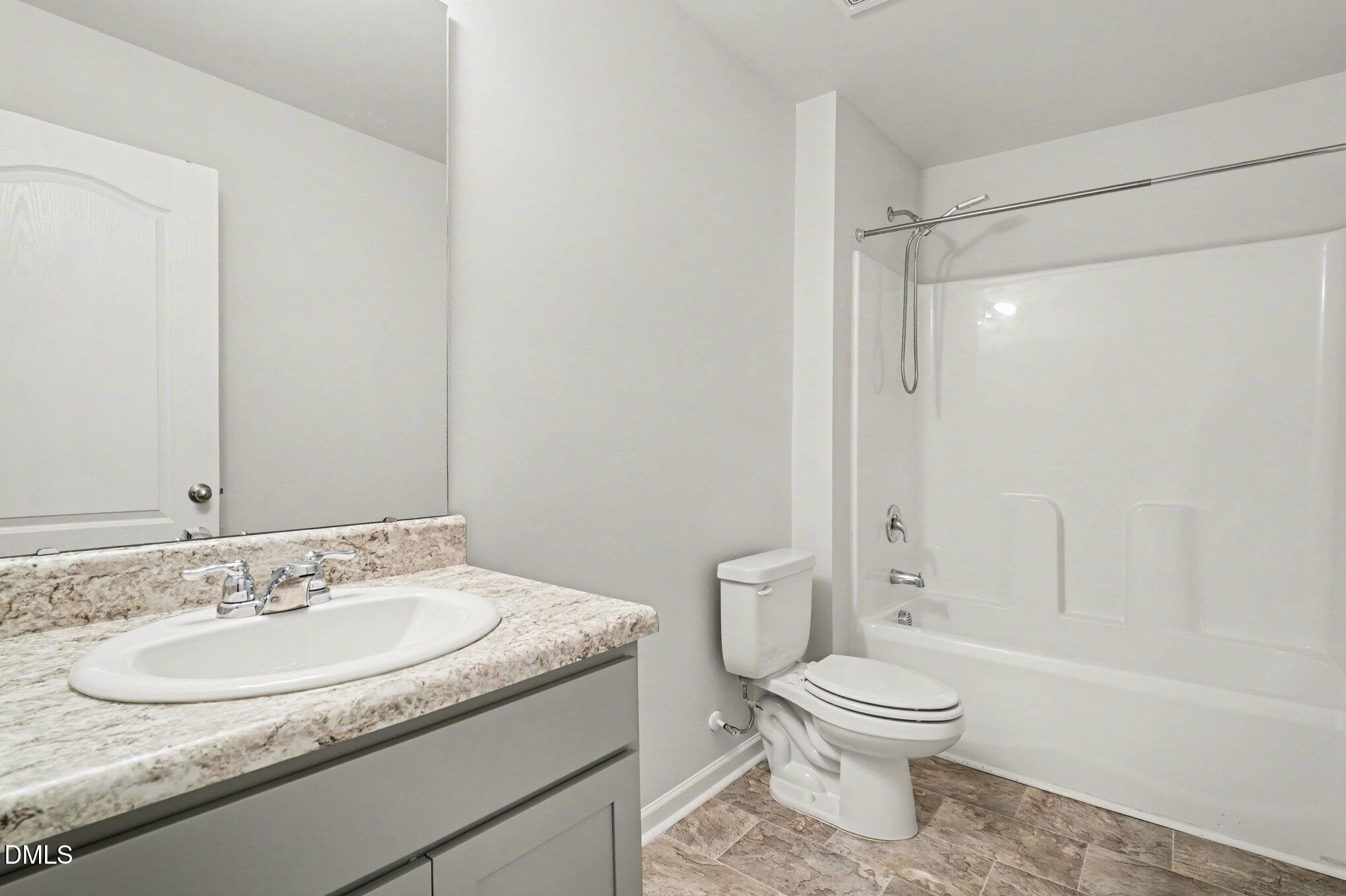 6003 Lowgrass Road Stedman, NC 28391 - Photo 18 of 24 a bathroom with a granite countertop sink toilet and shower