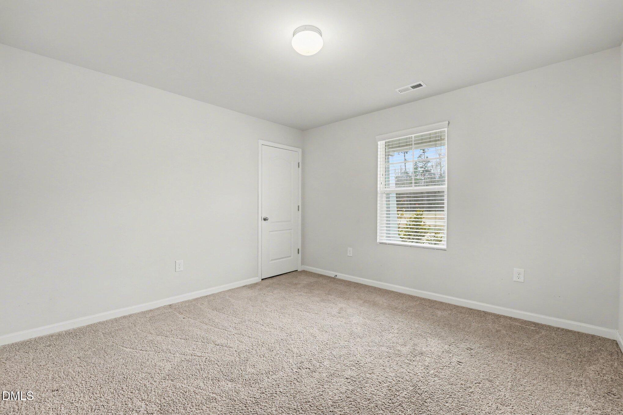 6003 Lowgrass Road Stedman, NC 28391 - Photo 19 of 24 an empty room with windows