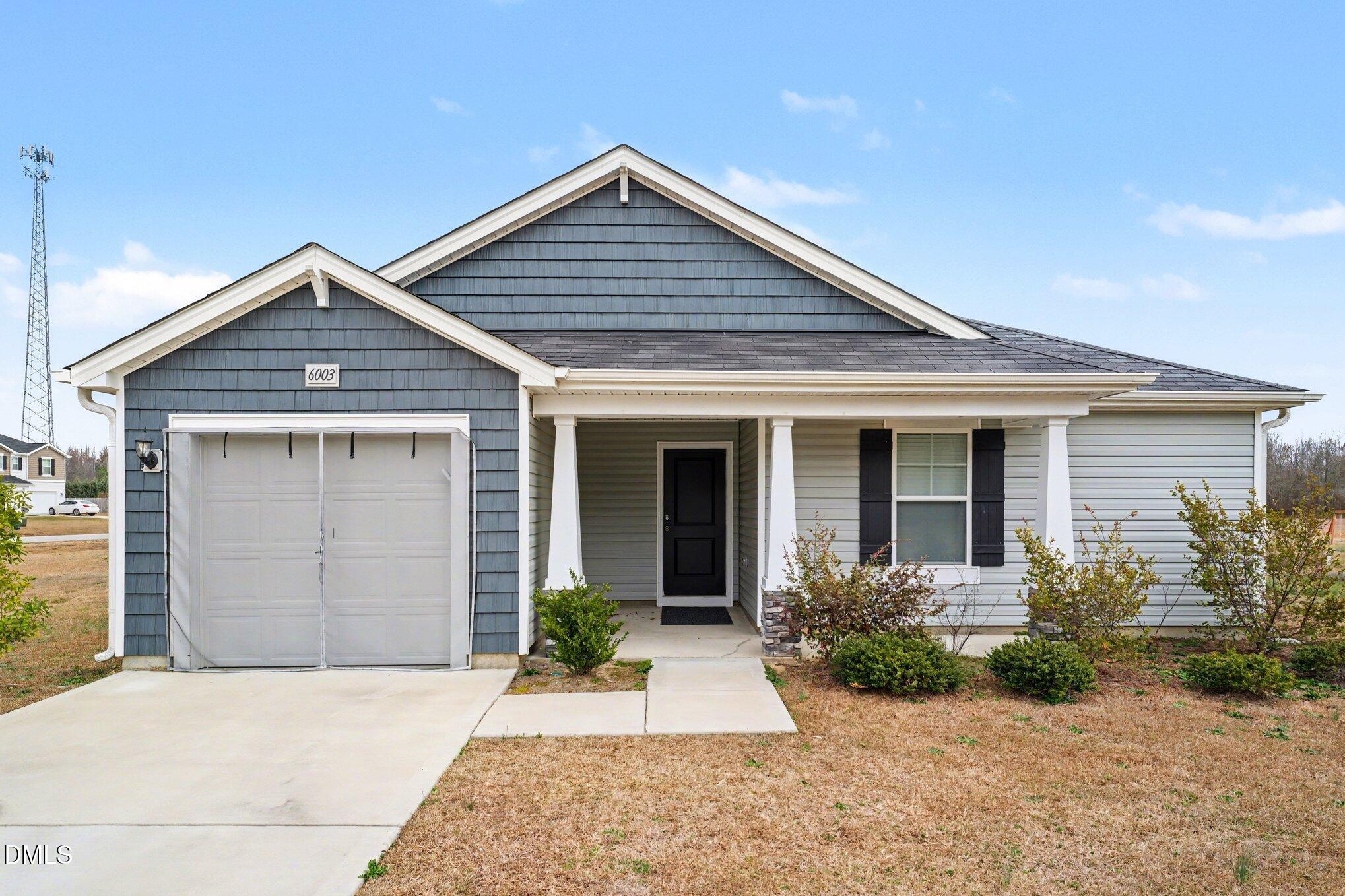 6003 Lowgrass Road Stedman, NC 28391 - Photo 2 of 24 a front view of a house with a garden