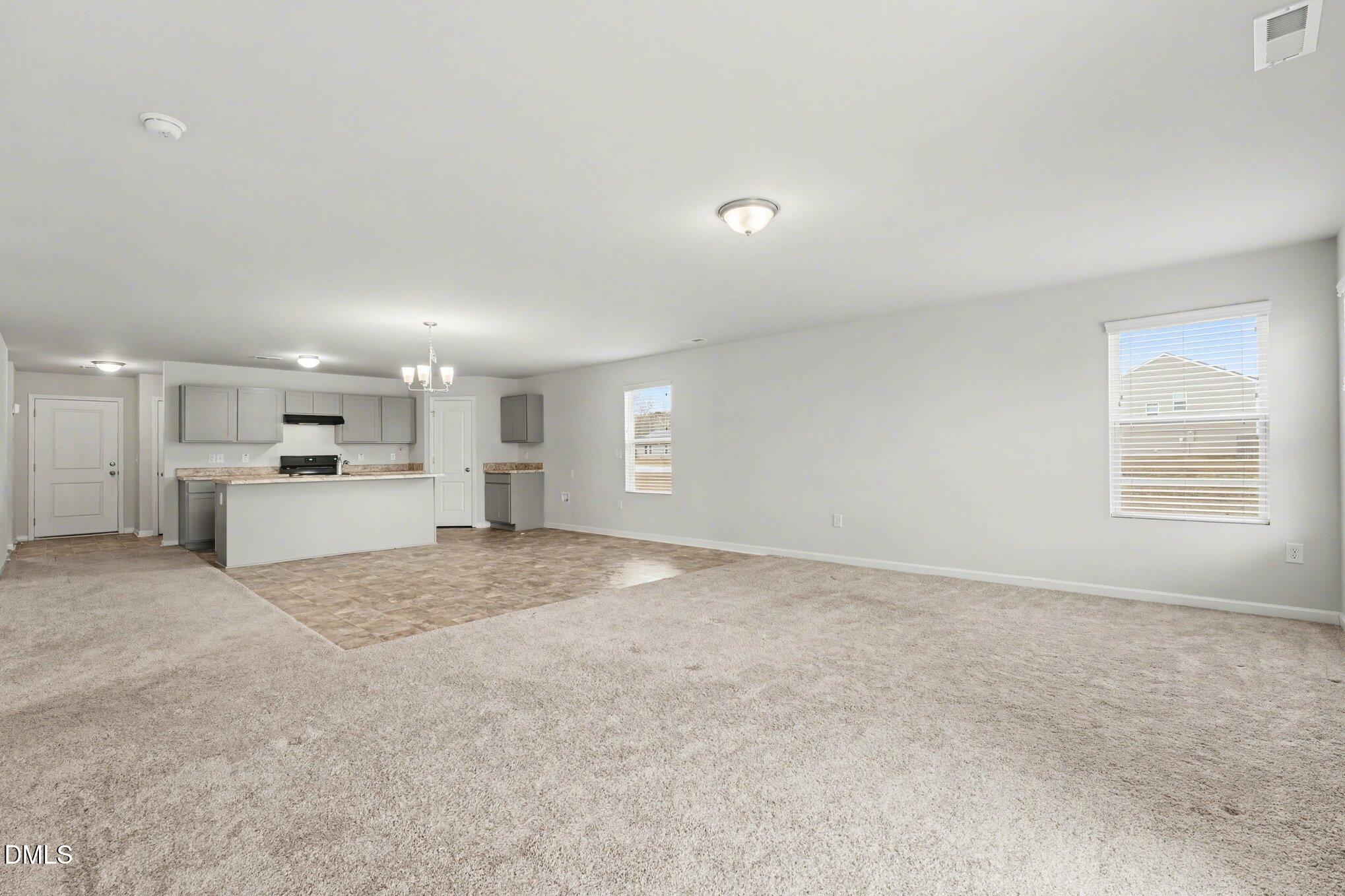 6003 Lowgrass Road Stedman, NC 28391 - Photo 10 of 24 a view of a kitchen with a sink and dishwasher a refrigerator with white cabinets