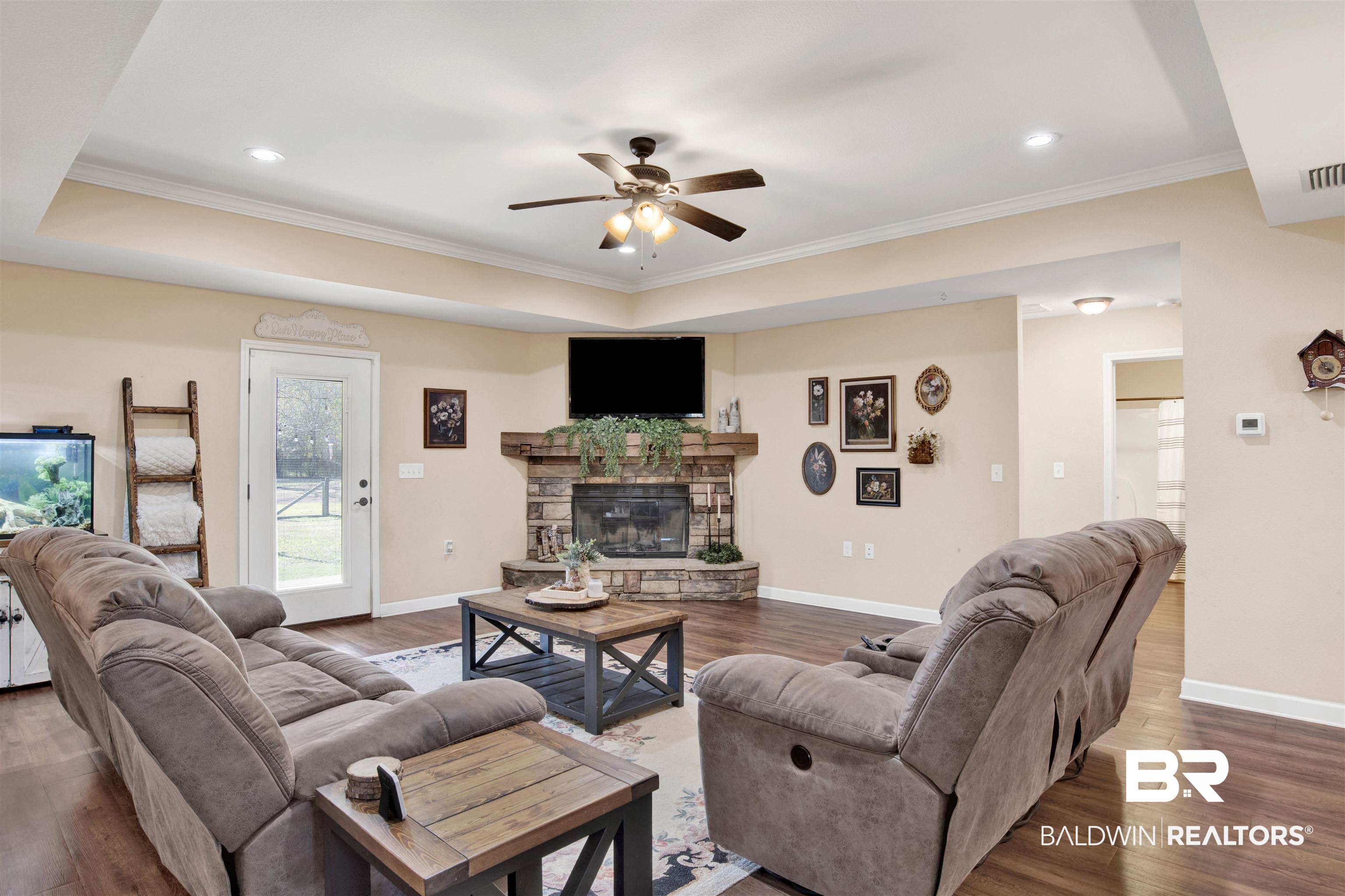 13676 Styx River Road Stapleton, AL 36578 - Photo 5 of 30 Living room with a fireplace, crown molding, ceiling fan, and dark wood-type flooring