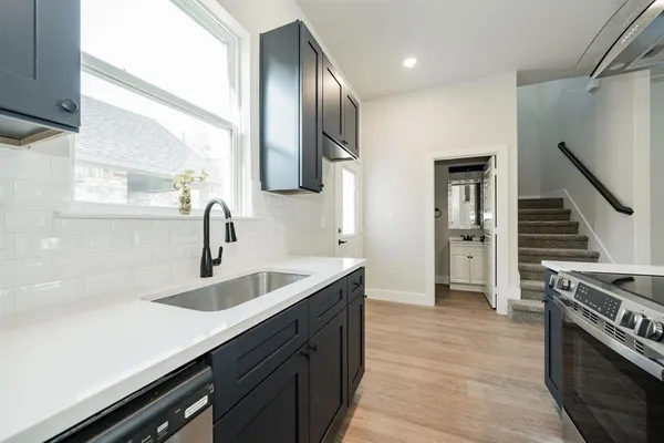 a large kitchen with a sink and dishwasher