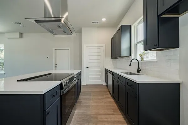 a kitchen with a sink and cabinets