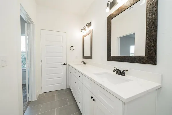 a bathroom with a shower sink and mirror