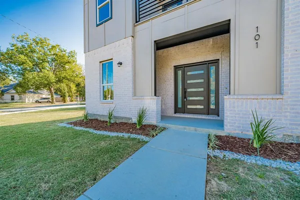 a front view of a house with garden