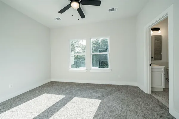 a view of a livingroom with a ceiling fan and entryway